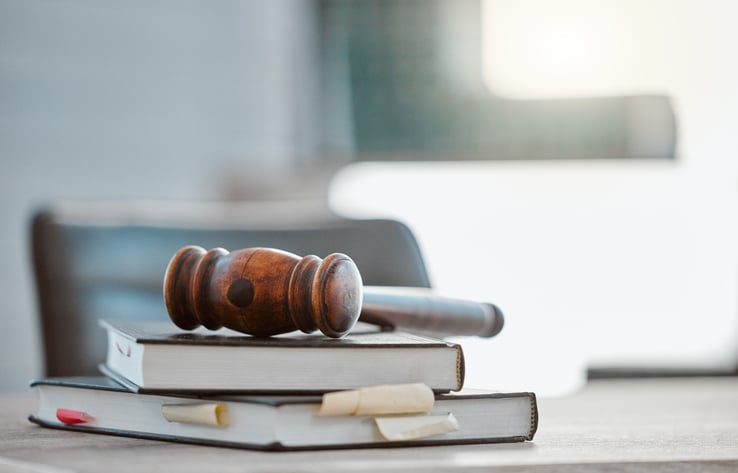 Justice, gavel and law books on table in office for court trial