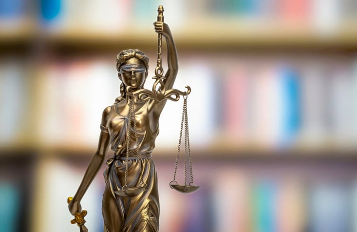THEMIS in front of blurred bookshelf background