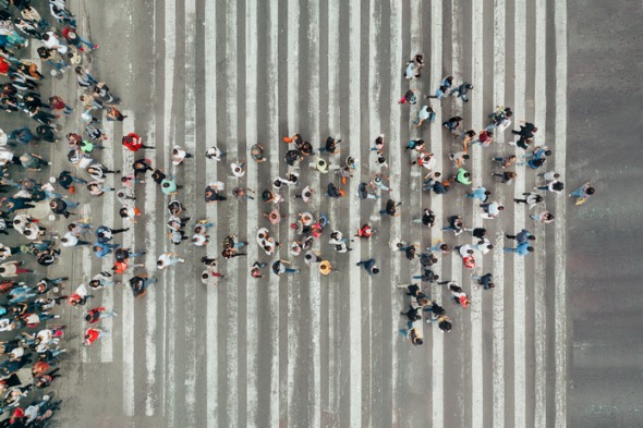 high-angle-view-of-people-forming-and-arrow-on-the-street-picture-id1069739918