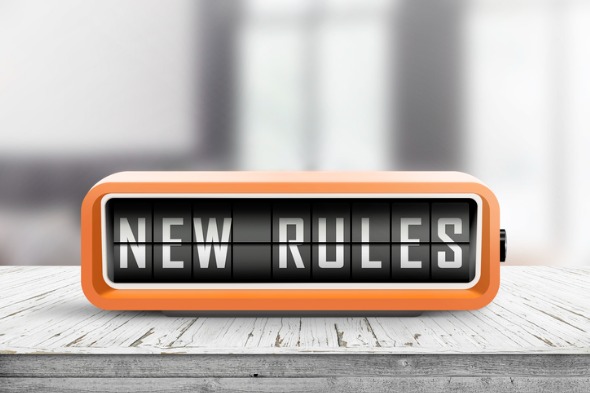 new-rules-alarm-message-on-a-wooden-desk-picture-id1136852280